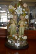 Victorian Glass Dome Containing Figurines of Children in a Floral Display