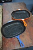 Two Le Creuset Cast Iron Skillets (One Orange, one Blue)