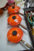Three Le Creuset Orange Enamel Cast Iron Pans
