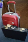 Small Red Delsey Suitcase and a Black Attache Case