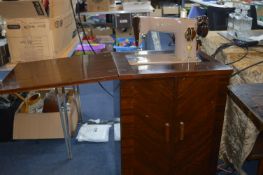 Singer Sewing Machine in Cabinet with Sewing Acces