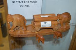Carved Wooden Elephants Pulling Logs