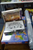 Four Unopened Jigsaw Puzzles and a Puzzle Roll