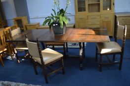 Dark Oak Extending Dining Table with Four Cream Le