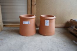 A pair of terracotta chimney pots
