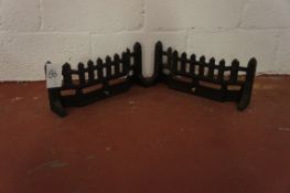 A pair of cast iron fire frets