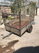 Small metal frame trailer with wooden sides in need of minor attention