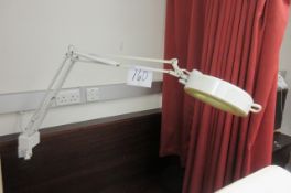 Three illuminated magnifiers on articulated spring arm