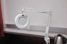 Three illuminated magnifiers on articulated spring arm
