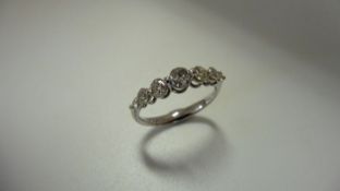 0.60ct diamond band ring set in 14ct white gold. 7 graduated brilliant cut diamonds