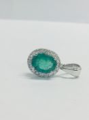14Ct White Gold Emerald And Diamond Pendant.