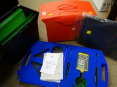 Cased electronic temperature machine, a black and a red document case and a zip-up leather type