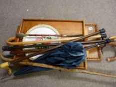 Two vintage wooden trays and one other and a quantity of walking sticks, canes and a vintage