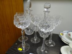 Two cut glass decanters and five long stem drinking glasses