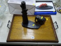 Vintage oak two handled tray and a carved lamp base with elephant figurine near a tree trunk