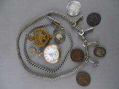 Vintage pocket watch with decorative dial, a silver Albert with T-bar, a selection of badges and