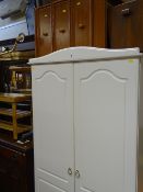 Modern white two door wardrobe, three drawer bedside chest and a mirror