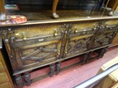 Oak railback sideboard with three drawers over three base cupboards all with brass drop handles