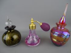 Two art glass scent bottles and a Caithness crackle glass example with puffer