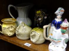 Two Ugly Pottery moneyboxes and a mug, a Staffs figurine, a German pottery jug etc