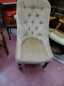 Button upholstered spoonback chair on brass castors