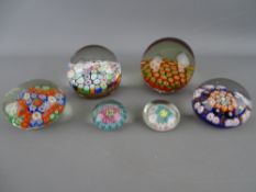 Six millefiori decorated glass paperweights