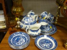 Parcel of blue Willow breakfast ware, an amber glass goblet and two brass based oil lamps
