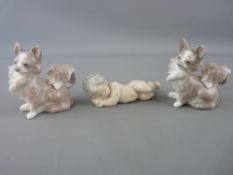 Three small Lladro figurines of a sleeping baby and a pair of Pomeranian terriers