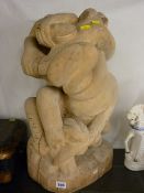 Carved wooden statue of entwined animals and snakes