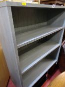 Modern lime washed style adjustable bookcase and a glass and chrome TV stand