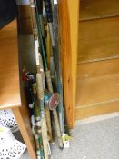 Parcel of fishing rods and reels and a box of reels and associated items (on table opposite)