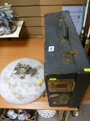 Fitted travelling case with old shipping labels and a frosty glass mushroom hanging light shade