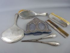 Four piece silver dressing table mirror, brush and comb set, an embossed hallmarked double
