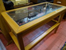Two reproduction light wood glass topped coffee tables