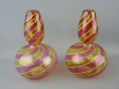 Pair of cranberry and vaseline swirl glass vases