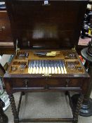 Mappin & Webb oak canteen table on barley twist supports, lift-up lid and single front drawer with