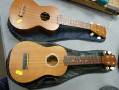 Two modern ukuleles in carry cases