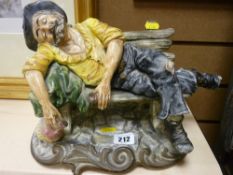 Capodimonte figure of an inebriated old man on a bench
