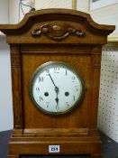 Oak encased circular dial mantel clock with eight day German striking movement
