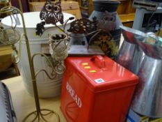 Metal bin containing metal jugs, red metal bread bin and an ornate tea light stand