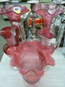 Pair of cranberry glass flute vases, two trail glass fancy jugs and a cranberry trail glass celery