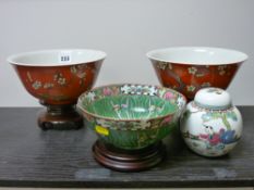 Pair of red ground floral painted Hong Kong bowls on stands, a Famille Vert Chinese bowl and a