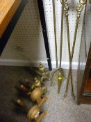 Three brass fire irons and two pairs of fire dogs