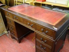 Reproduction mahogany twin pedestal desk with gilt tooled red leather top