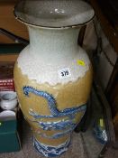Large Oriental crackle glazed vase decorated in relief with a four toed dragon facing a tiger (