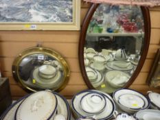 Convex brass framed circular wall mirror and an oval mahogany framed wall mirror