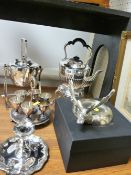 Two EPNS spirit kettles on stands, an eggset, a candleholder and a stag ornament in a box