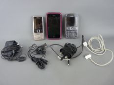 Two Nokia mobile phones with chargers and a Sketch with connector