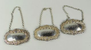 A set of three Elizabeth II silver wine labels for 'Sherry', 'Gin' & 'Port' inscribed Condition