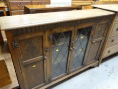 A good carved & glazed bookcase / bookcase cupboard, 134cms wide Condition reports are provided on